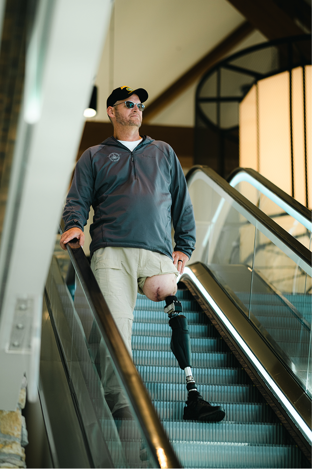 An OPRA™ Implant System patient using an escalator.
