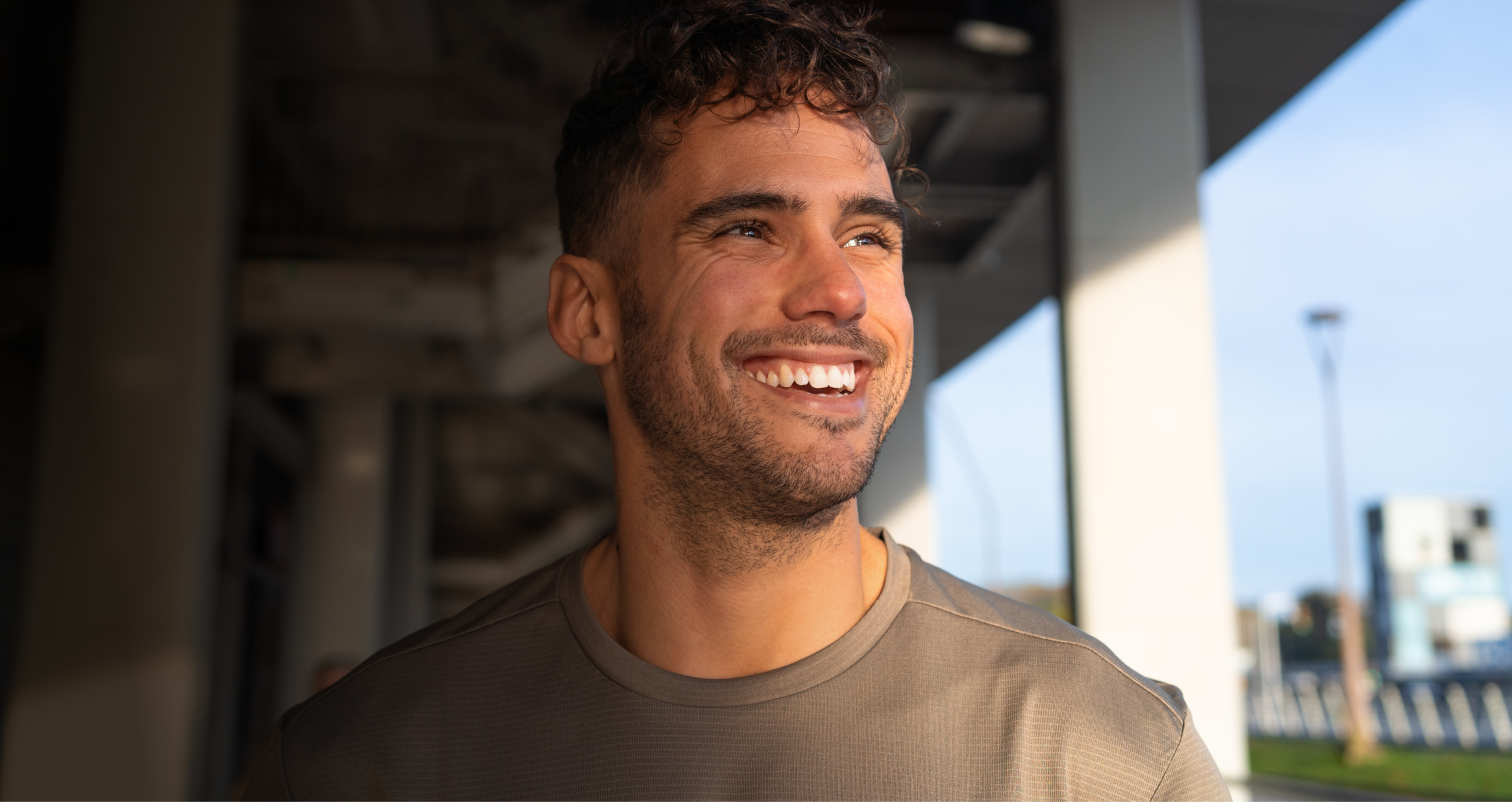 Portrait of young male smiling indoors.