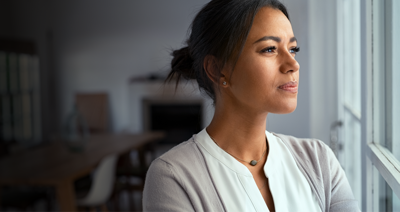Woman in clinical setting smiling.