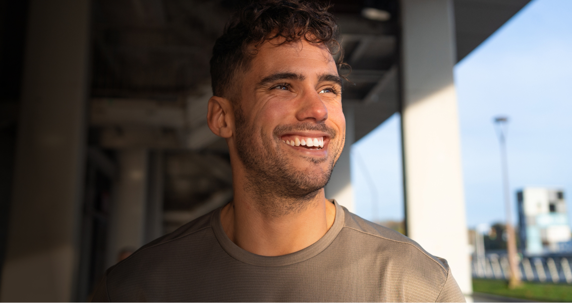 Portrait of young male smiling indoors.