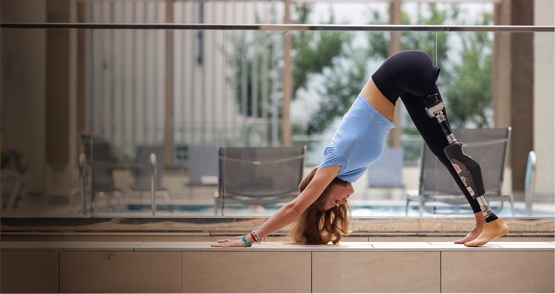 An OPRA™ Implant System patient performing yoga pose Indoors.