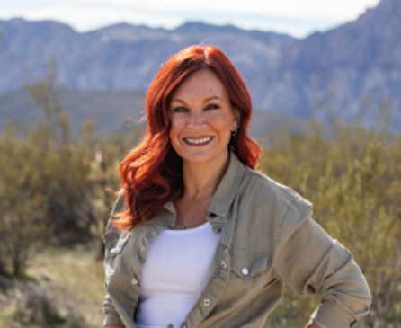 Closeup of Stacey in desert landscape.