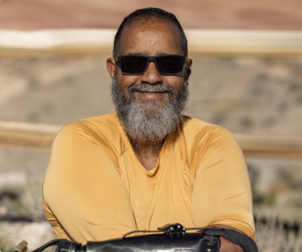 Portrait of Wayne, an OPRA™ Implant System patient, seated outdoors.