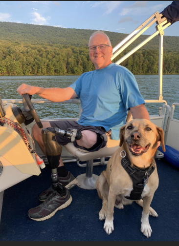 An OPRA™ Implant System patient in boat with dog.